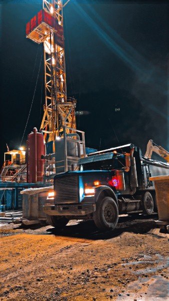 Dump truck at a drilling rig at night
