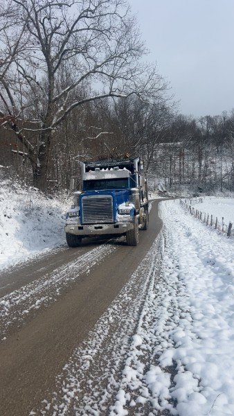 Dump truck climbing a snowy back road