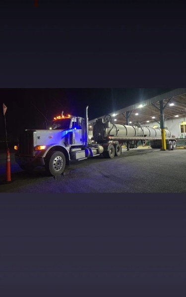 Tanker loading at a facility at night