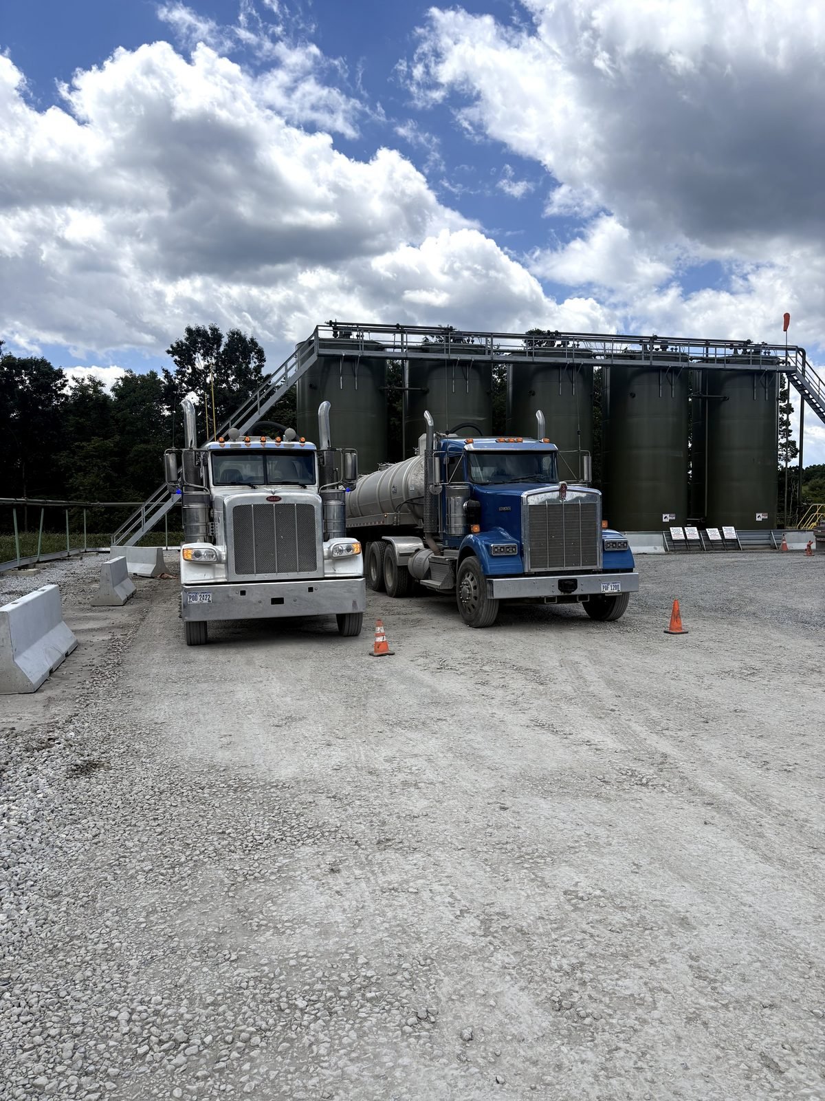 Two blue rigs staged on site